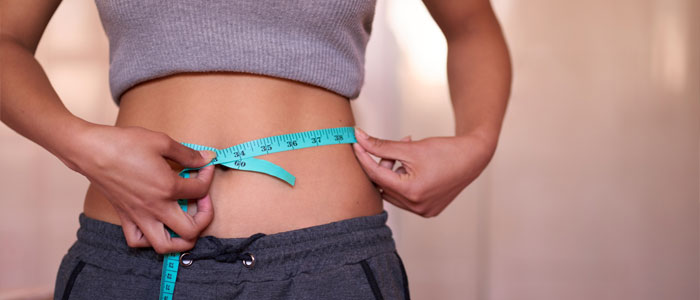 a woman with tape measure around her waste 